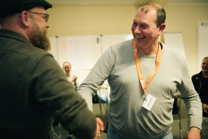 Participant receives his certificate from the trainer